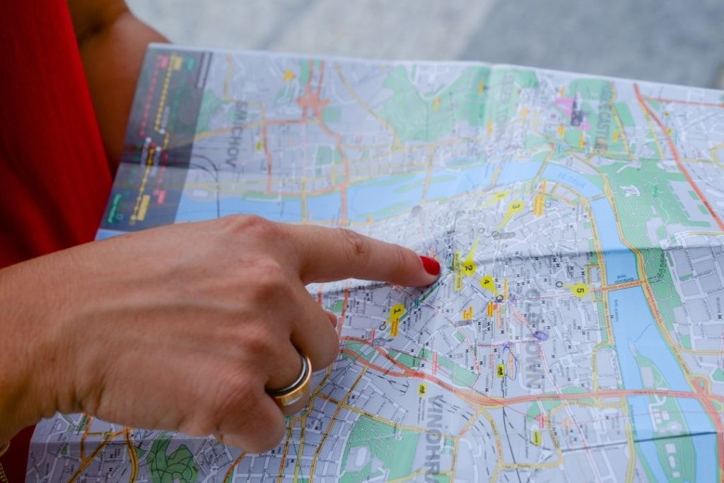 woman points to a place on a map
