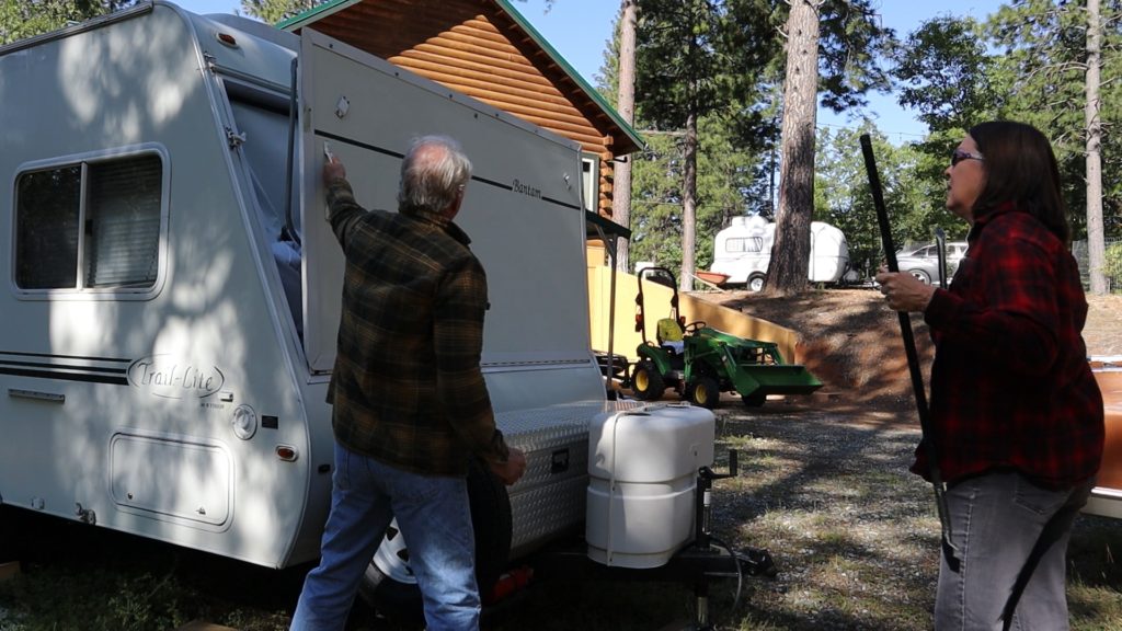 man deploys hybrid travel trailer
