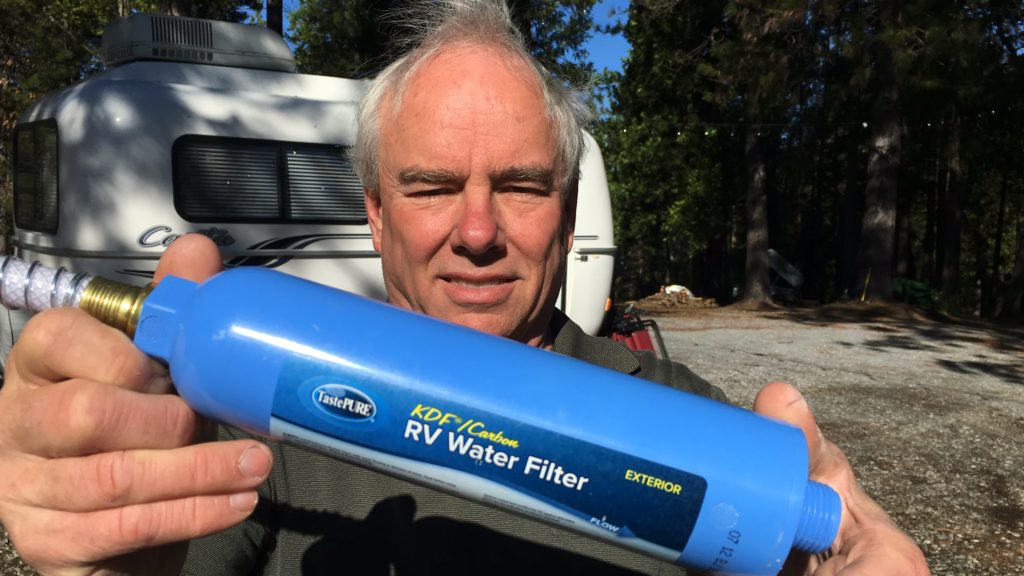 man displays an RV water filter