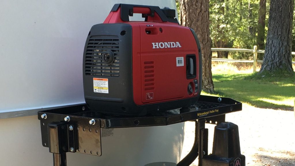 a honda generator sits on a stromberg-carlson trailer tray on a casita trailer