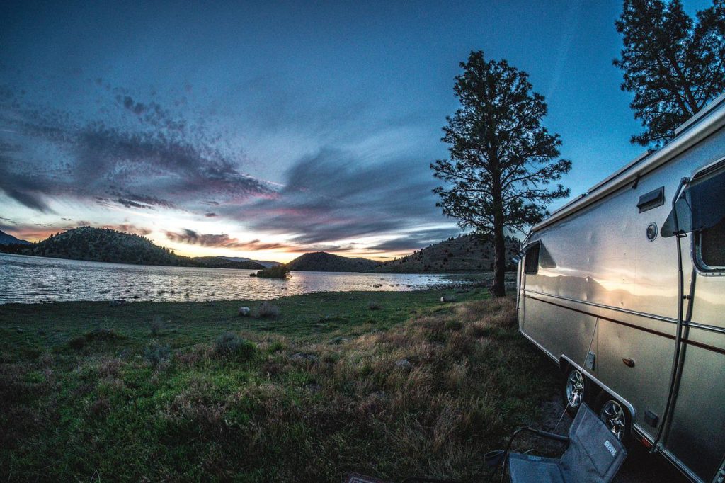 Airstream camped next to a lake
