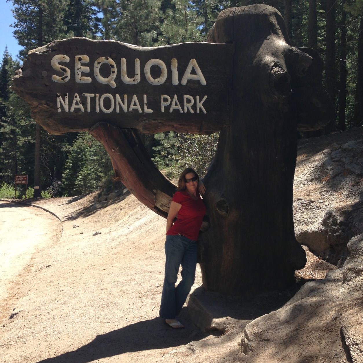 Author standing in front of sign at Sequoia National Park