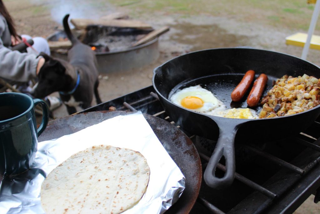 Pan with breakfast cooking on the fire