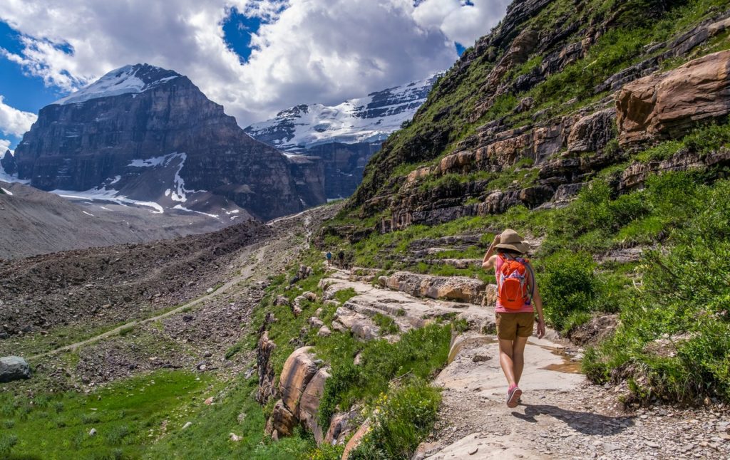 a woman hikes through a trail in the mountains