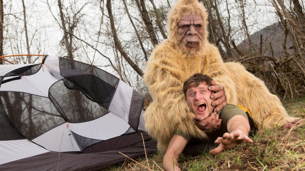 Bigfoot holding man's head - man screaming