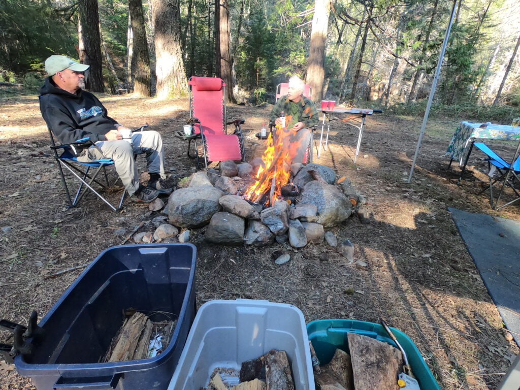 Author's husband and friend visit by the campfire at a dispersed campsite