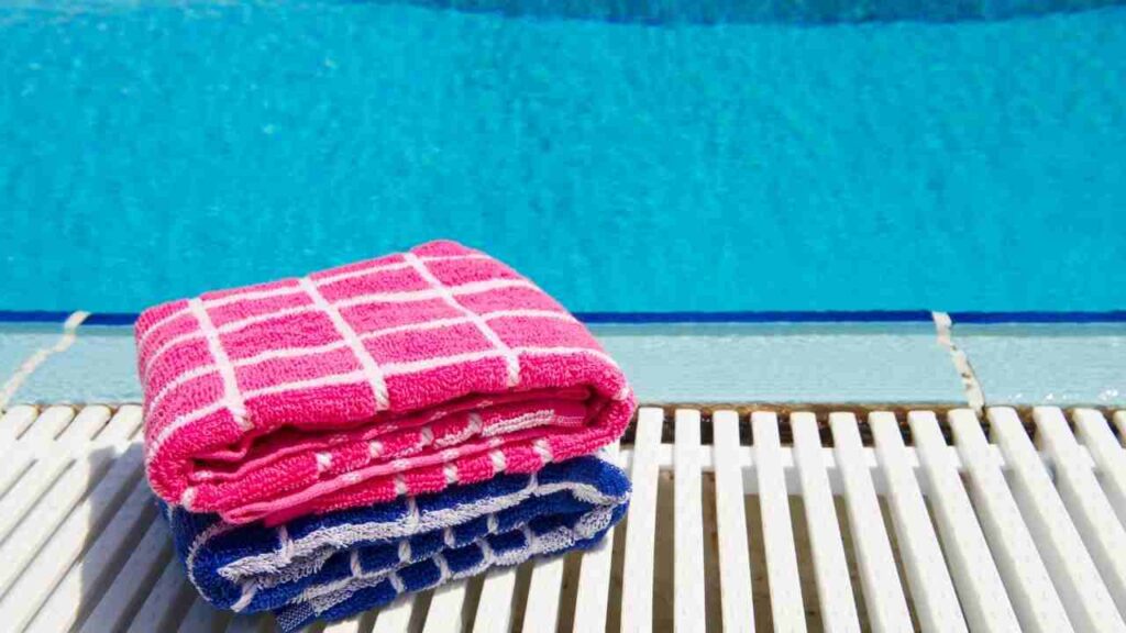two towels next to a swimming pool