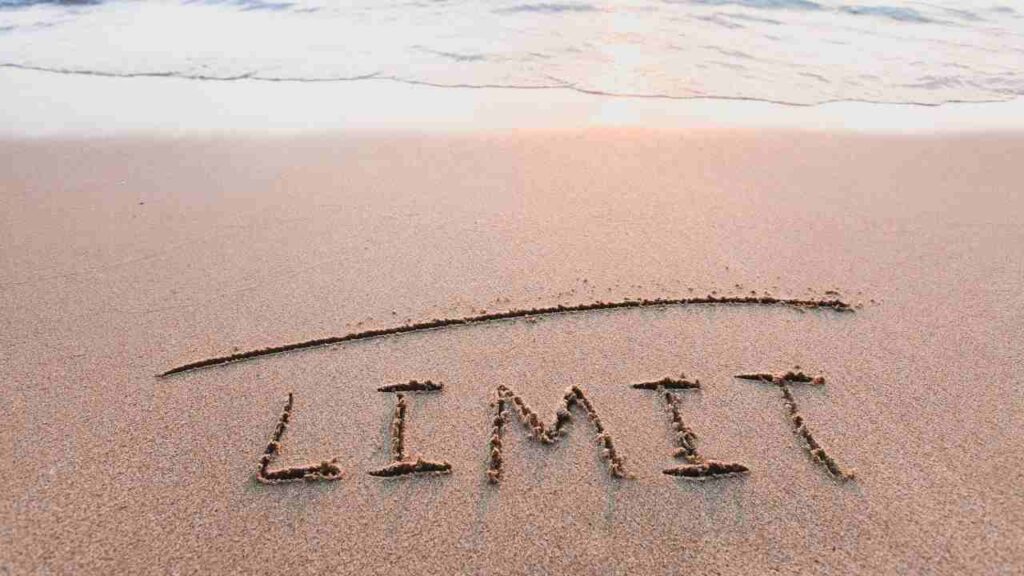 The word "limit" written in the sand