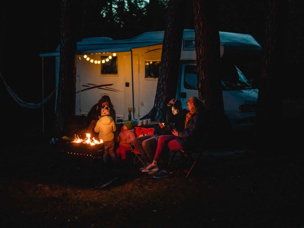 RV with string lights by the campfire
