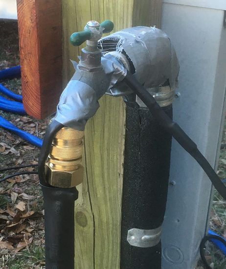 rv hooked up to the faucet of with a heated water hose