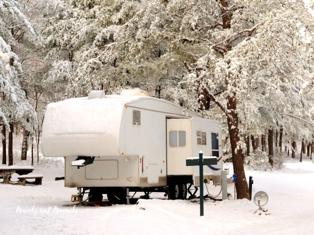 an rv parked at a snowy campground