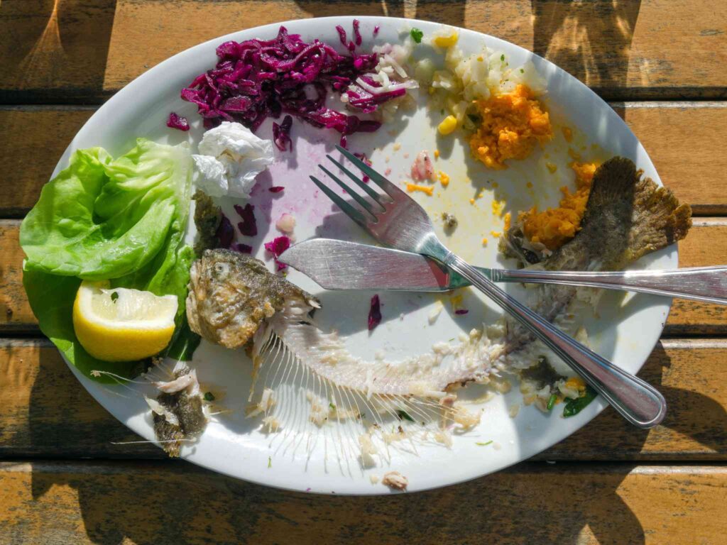 a plate with half the food eaten