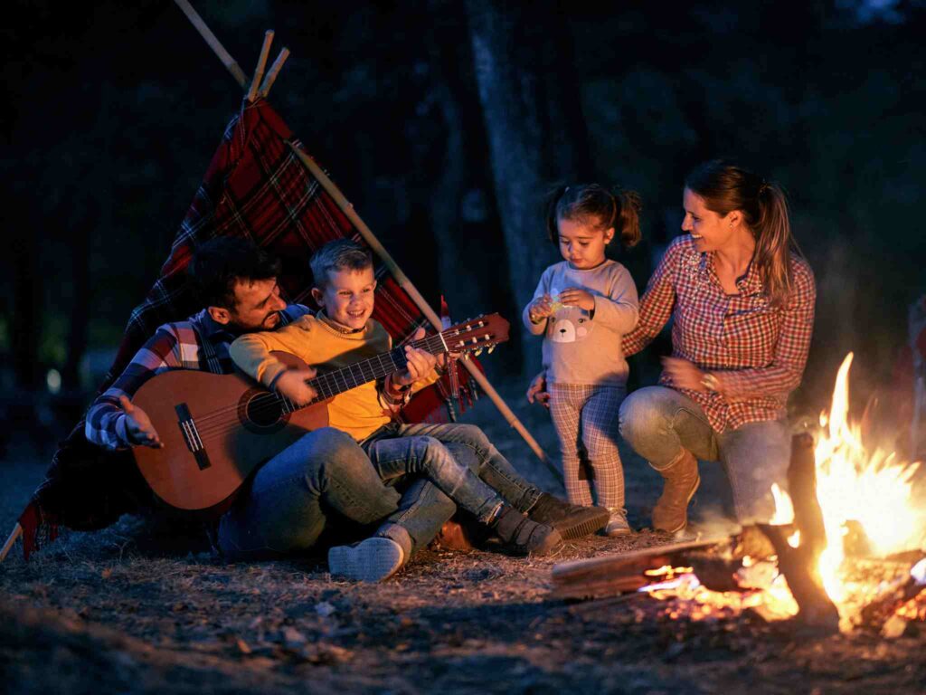 a family sings songs in front of a campfire